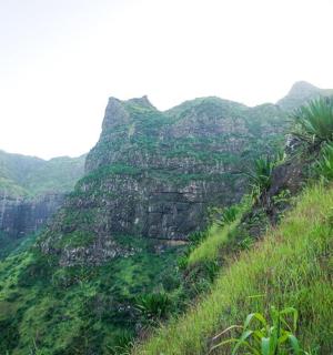 a view of a mountain with grass and rocks