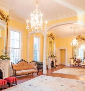 a large living room with a fireplace and a chandelier