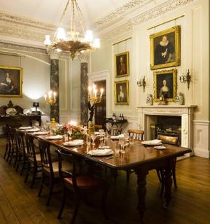 a dining room with a long table and a fireplace