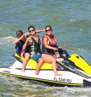 a group of people riding on a jet ski in the water