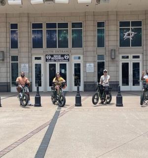 a group of people riding bikes in front of a building