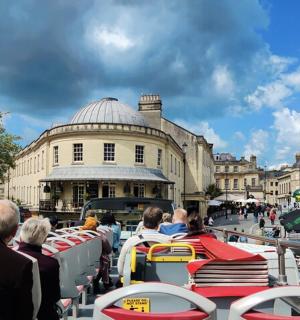 a group of people riding on a tram in a city