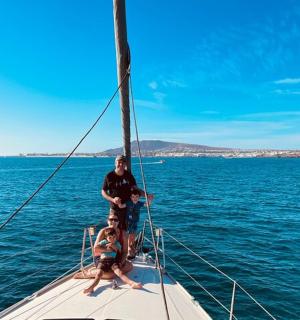 一名男子和两个孩子站在船头