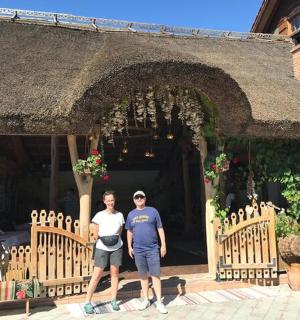 a man and a woman standing in front of a building