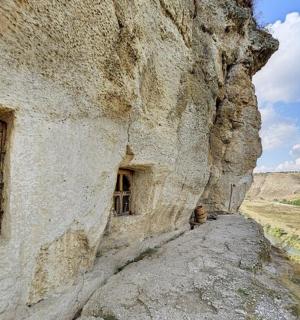 a building on the side of a rocky mountain