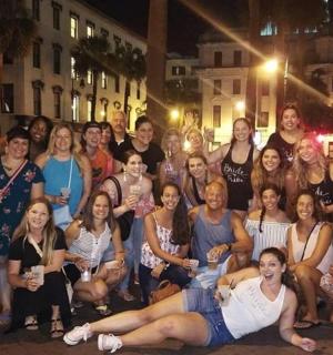 a group of people posing for a picture on the street