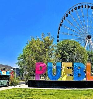 a ferris wheel and a sign in front of a park