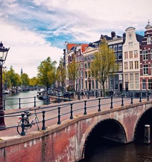 a bridge over a river in a city with buildings