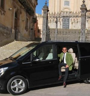 a man sitting in the back of a black van