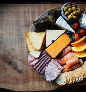 a plate of cheese and fruit on a table