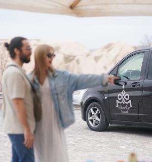 a man and a woman standing next to a van
