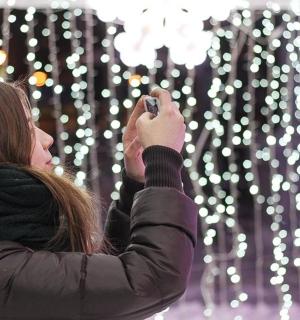 a woman taking a picture with her cell phone