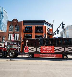 a tow truck is pulling a bus on a street