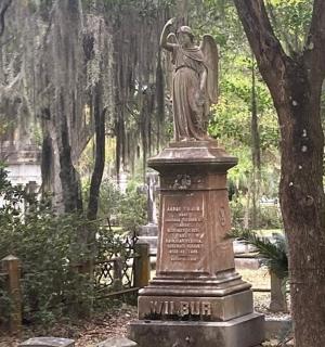 a statue of a woman sitting in a park