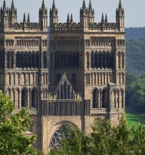 a large castle building with trees in the foreground