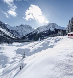 a train traveling through a snow covered mountain