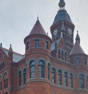 a large red brick building with a clock tower