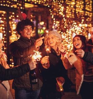 a group of people standing around at a christmas party