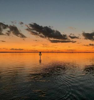 a sunset over a large body of water