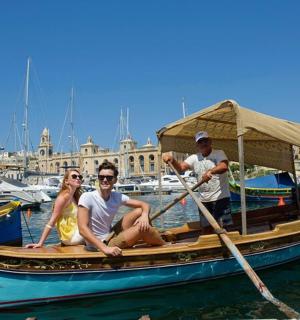 a group of people sitting on a boat in the water