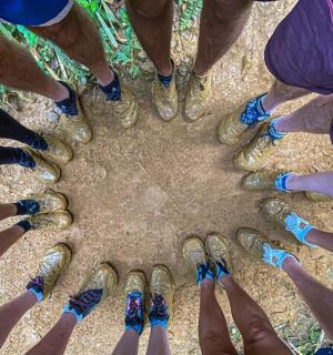 a group of people with painted nails and their hands in a circle