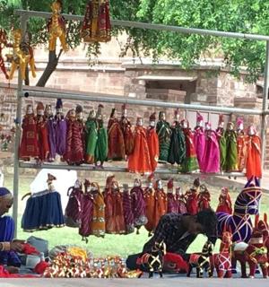 a group of people sitting in front of a rack of clothes