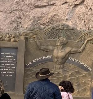 a group of people standing in front of a statue