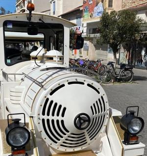 a white train engine sitting on a city street