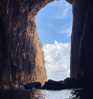 a view of a cave from the water