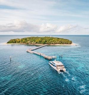 an island with a boat in the middle of the water