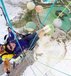 a man is in a zipline with balloons