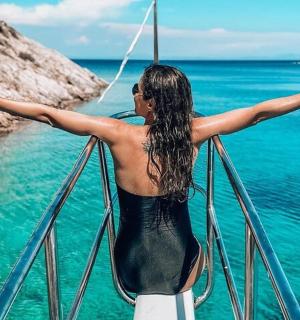 a woman standing on a boat in the ocean