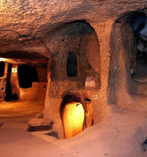 a dark room with a cave with a light in it