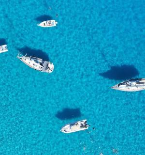 a group of boats in the blue water