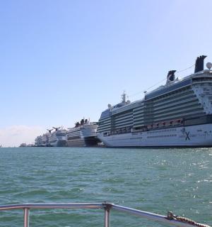 two cruise ships are docked in the water
