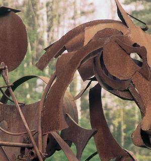 a metal statue of a horse on a pole