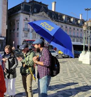 a group of people walking down a street with an umbrella