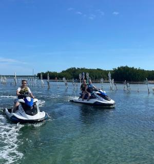 三个人骑着水上踏板在湖上