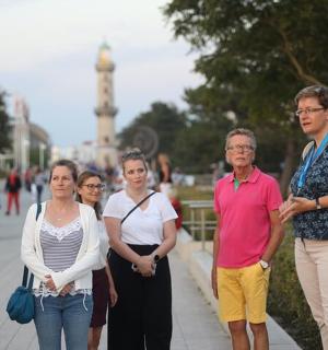 a group of people walking down a sidewalk
