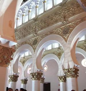 a large building with white columns and ornate ceilings