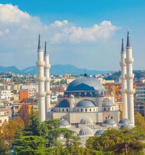 a mosque with two domes on top of a city