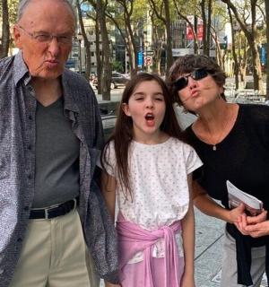 a man and a woman standing next to a little girl