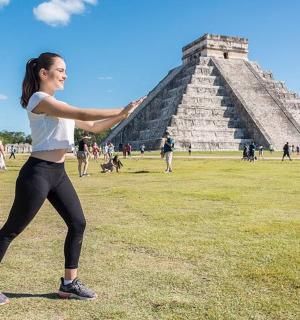 a woman standing in front of the pyramid