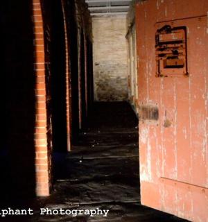 an empty hallway in an old brick building