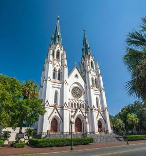 a large white church with two towers on a street