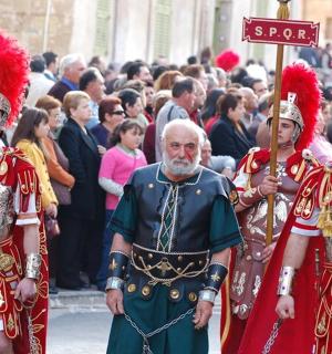 a group of men in costumes walking down a street