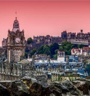 a city with a clock tower on a hill