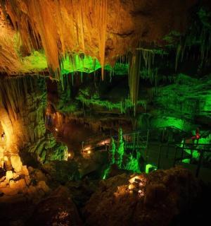 a cave with green lights in the ceiling