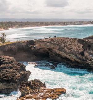 a view of the ocean from a rocky shoreline