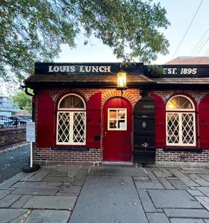 a red building with a red door on a street
